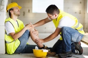A construction worker tends to his injured coworker