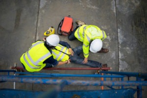 A construction worker tends to an injured coworker
