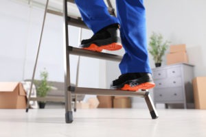 construction worker climbing a ladder