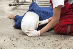 worker assisting a construction worker who fell on the job