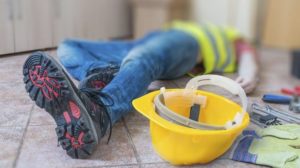 construction worker lying on the floor after falling off a ladder