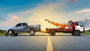 tow-truck hauling a pick-up truck