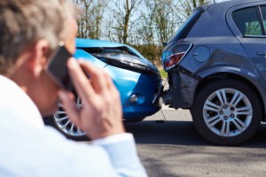 man calling for help after a car accident