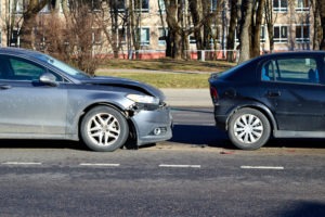 car with front bumper damage after a rear-end accident