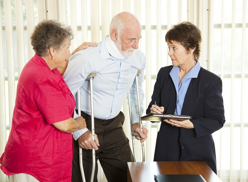 injured man consulting with lawyer