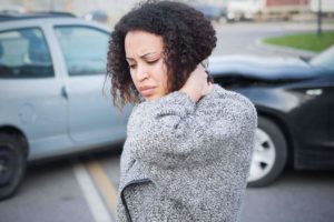 woman gripping neck after car accident